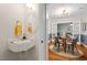 Stylish powder room with modern fixtures and a dining room in view for elegant convenience during gatherings at 1826 Northgate St, Durham, NC 27704