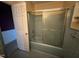 This bathroom features a blue tub and tile surround with sliding glass doors at 202 Camelia Dr, Princeton, NC 27569