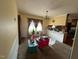 Sun-filled dining area with large windows, chandelier lighting, and a view into the kitchen at 202 Camelia Dr, Princeton, NC 27569