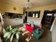 Bright dining room with yellow walls, chandelier lighting, and a view into the kitchen at 202 Camelia Dr, Princeton, NC 27569