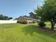 Well-maintained brick home featuring manicured landscaping, a fenced yard and mature trees at 202 Camelia Dr, Princeton, NC 27569