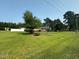 Traditional brick home with large front yard, mature trees, and well-maintained landscaping at 202 Camelia Dr, Princeton, NC 27569
