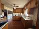Functional kitchen with wood cabinets, laminate floors and stainless steel sink at 202 Camelia Dr, Princeton, NC 27569