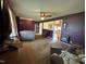 Spacious living room with purple walls, ceiling fan and view of the kitchen at 202 Camelia Dr, Princeton, NC 27569