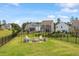 Spacious backyard featuring a cozy fire pit with chairs, black metal fence and lush green lawn at 209 Sage Oak Ln, Holly Springs, NC 27540