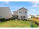 Well-maintained backyard featuring a charming garden, lush green grass, and an inviting screened porch at 209 Sage Oak Ln, Holly Springs, NC 27540