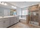 Spacious bathroom with double vanity, soaking tub, glass-enclosed shower and stylish fixtures at 209 Sage Oak Ln, Holly Springs, NC 27540