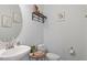 Cozy half-bathroom with modern fixtures, decorative shelf, and neutral paint at 209 Sage Oak Ln, Holly Springs, NC 27540