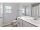 Bright bathroom featuring a vanity, sink, decorative window, and a shower with tile surround at 209 Sage Oak Ln, Holly Springs, NC 27540