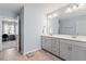 Bright primary bathroom with double sinks, vanity, and tile floor at 209 Sage Oak Ln, Holly Springs, NC 27540