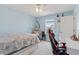 Bright bedroom with a egg chair, and neutral decor with view from the window at 209 Sage Oak Ln, Holly Springs, NC 27540