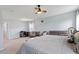 Large bedroom with desk and chair workspace, featuring ceiling fan and natural light at 209 Sage Oak Ln, Holly Springs, NC 27540