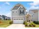 Charming two-story home with a well-maintained lawn and attached two-car garage at 209 Sage Oak Ln, Holly Springs, NC 27540