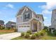 Beautiful two-story home with stone accents, landscaping, and an attached two-car garage at 209 Sage Oak Ln, Holly Springs, NC 27540