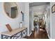 Inviting foyer featuring wood floors, decorative mirror, console table, and neutral paint at 209 Sage Oak Ln, Holly Springs, NC 27540