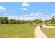 Expansive green golf course view with landscaped pathway at 209 Sage Oak Ln, Holly Springs, NC 27540