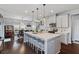 Bright kitchen with a large island, pendant lighting, and stainless steel appliances at 209 Sage Oak Ln, Holly Springs, NC 27540