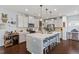 Stylish kitchen featuring an island with seating, white cabinets, and modern backsplash at 209 Sage Oak Ln, Holly Springs, NC 27540