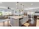 Open concept kitchen with island seating flows into a dining and living area at 209 Sage Oak Ln, Holly Springs, NC 27540