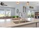 Bright kitchen island sink with backyard views and an open concept living space at 209 Sage Oak Ln, Holly Springs, NC 27540