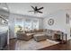 Spacious living room with fireplace, plenty of natural light, and dark wood floors at 209 Sage Oak Ln, Holly Springs, NC 27540