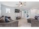 Neutral living room with ceiling fan, and comfortable brown sofa, providing an inviting and relaxing living space at 209 Sage Oak Ln, Holly Springs, NC 27540