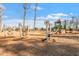 Community playground with swings, a slide, and other play structures with wood chip ground covering at 209 Sage Oak Ln, Holly Springs, NC 27540