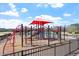 Well-equipped community playground with climbing features and slides, fenced in at 209 Sage Oak Ln, Holly Springs, NC 27540