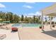 Outdoor pool with lounge chairs and umbrellas and a blue sky with scattered clouds at 209 Sage Oak Ln, Holly Springs, NC 27540