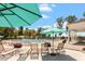 Various umbrellas and lounge chairs around a swimming pool with lap lanes with flower boxes at 209 Sage Oak Ln, Holly Springs, NC 27540