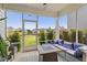 Comfortable screened porch with patio furniture, offering views of the fenced backyard at 209 Sage Oak Ln, Holly Springs, NC 27540