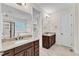 Luxurious bathroom featuring double vanities with granite countertops and a separate tub and shower at 216 Pondside Dr, Apex, NC 27539