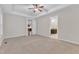 Inviting bedroom boasts neutral carpet and tray ceiling, with access to a bathroom at 216 Pondside Dr, Apex, NC 27539