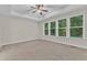 Spacious bedroom with tray ceiling and three large windows providing plenty of natural light at 216 Pondside Dr, Apex, NC 27539