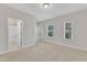 This bedroom boasts neutral carpet and three windows letting in plenty of light at 216 Pondside Dr, Apex, NC 27539