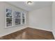 Cozy bedroom with hardwood floors, three large windows, and ample natural light at 216 Pondside Dr, Apex, NC 27539
