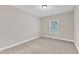 A modest bedroom featuring carpeted floors, light-colored walls, and a bright window at 216 Pondside Dr, Apex, NC 27539
