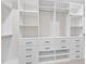 Custom walk-in closet offering ample storage space with built-in shelving and drawers at 216 Pondside Dr, Apex, NC 27539