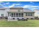 Exterior of home with a screened-in porch and stone patio extending into the yard, providing outdoor living at 216 Pondside Dr, Apex, NC 27539