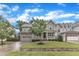 Charming two-story home featuring a stone facade, covered porch, and well-manicured lawn at 216 Pondside Dr, Apex, NC 27539