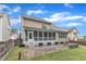 Back of home with a screened-in porch and stone patio, perfect for outdoor gatherings and relaxation at 216 Pondside Dr, Apex, NC 27539