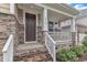 Close-up of the front porch with stone detailing and a welcoming front door at 216 Pondside Dr, Apex, NC 27539