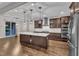 Modern kitchen with a large island, pendant lighting, and stainless steel appliances at 216 Pondside Dr, Apex, NC 27539