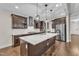 Gourmet kitchen with a large island, stainless steel appliances, and custom cabinetry at 216 Pondside Dr, Apex, NC 27539