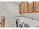 Well-equipped laundry room featuring a new washer and dryer set, and granite countertop at 216 Pondside Dr, Apex, NC 27539