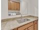 Granite countertop vanity with a sink in the laundry room features overhead cabinet storage at 216 Pondside Dr, Apex, NC 27539