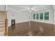 The hardwood living room has a fireplace, ceiling fan, and multiple bright windows at 216 Pondside Dr, Apex, NC 27539