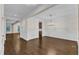 Bright living room featuring hardwood floors, elegant wainscoting, and an open floor plan at 216 Pondside Dr, Apex, NC 27539