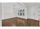 Elegant living room with hardwood floors, wainscoting, large windows, and a front door at 216 Pondside Dr, Apex, NC 27539