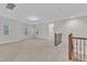 Bright loft area with natural light, with access to a bedroom and decorative wrought iron banister at 216 Pondside Dr, Apex, NC 27539